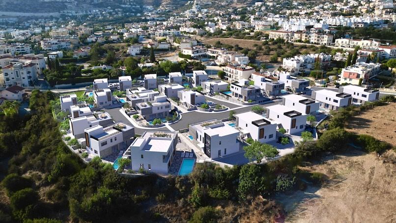 Aerial photograph of the Sentiero Luxury Villas site with digitally rendered villas overlaid, illustrating the full development within its actual landscape.